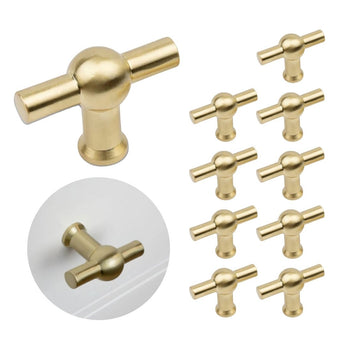 Een set van tien 10x Rando Gold Knob van yessential.nl; één gouden knop is linksonder geïnstalleerd op een witte lade.