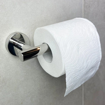 De Romano Chroom WC-set van yessential.nl heeft een rol wit toiletpapier met een golvend reliëfontwerp op een glanzend chromen houder, waardoor het een stijlvolle toevoeging is aan je badkameraccessoires op licht betegelde muren.