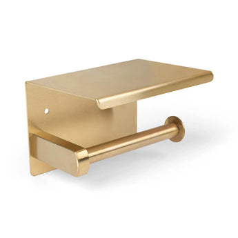 De Tazio Gold van yessential.nl is een goudkleurige, wandgemonteerde toiletrolhouder met planchet voor kleine items, stijlvol afgebeeld tegen een witte achtergrond.