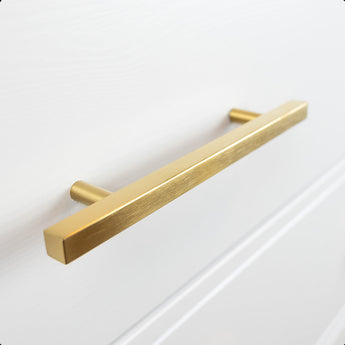 Een close-up van de Marano Gold rechthoekige handgreep van yessential.nl, elegant gemonteerd op een wit kast- of ladefront.