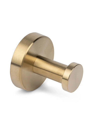 De Kyano Gold Hook van yessential.nl is een ronde haak van geborsteld messing voor aan de muur met een cilindrische pin en ronde basis - perfect om elegant handdoeken of jassen aan op te hangen in de badkamer.