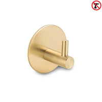 De Rudro Gold van yessential.nl is een gouden cilindervormige handdoekhaak met een ronde basis. Een no-drill icoon geeft aan dat het een handdoekhaak zonder boren is, waardoor installatie eenvoudig is - boren is niet nodig.