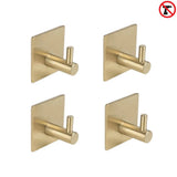 Vier yessential.nl 4x Navarro Gold wandhaken met vierkante voet zijn gerangschikt in een raster. Een rood no drilling icoon geeft aan dat deze haken makkelijk te installeren zijn zonder te boren-perfecte handdoekhaak zonder boren voor jouw ruimte.