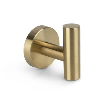 De Rodrigo Gold Haak van yessential.nl heeft een cilindervormig, goudkleurig ontwerp met een ronde basis - ideaal als stijlvolle handdoekhaak badkamer, afgebeeld op een witte achtergrond.