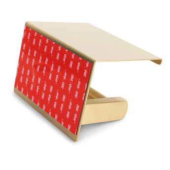 De Ludo Gold WC Set van yessential.nl is voorzien van een goudkleurige metalen clip met een schuine rechthoekige bovenkant en een rode 3M VHB-kleeflaag, waarmee je de set eenvoudig en zonder boren onder je toiletaccessoires kunt monteren.